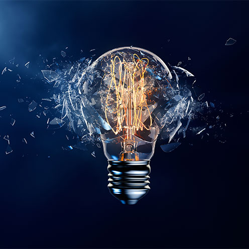 Exploding light bulb on a blue background