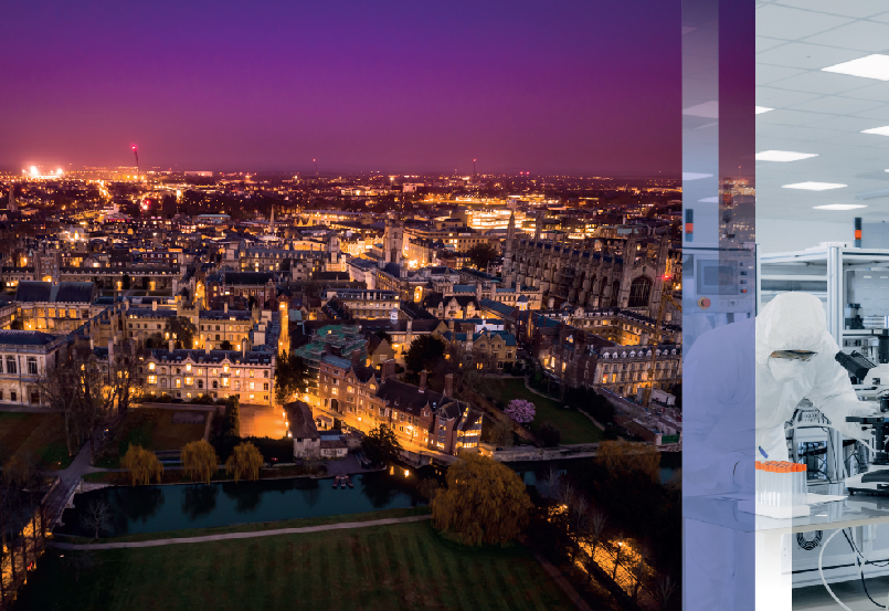 Night shot above Cambridge with the city light up below a purple sky.